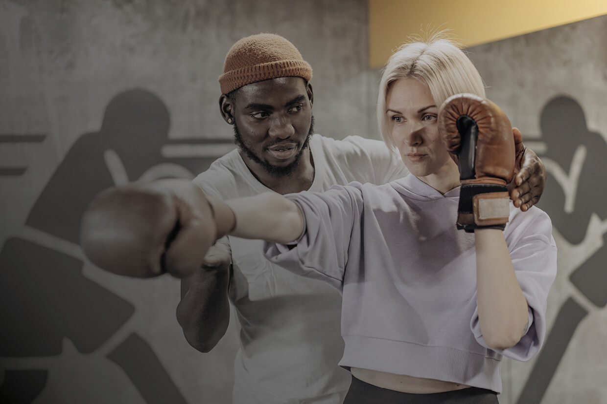 Men about to spar wearing headgear and touching gloves